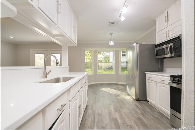 kitchen featuring light hardwood / wood-style floors, white cabinetry, sink, and appliances with stainless steel finishes