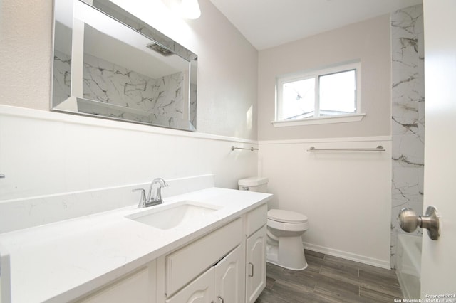 bathroom featuring wood-type flooring, vanity, and toilet