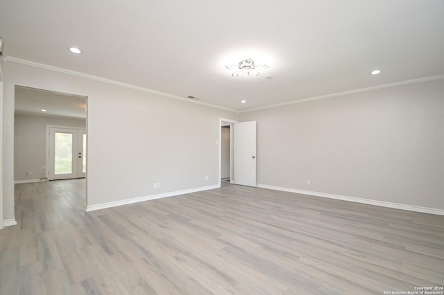 unfurnished room with french doors, crown molding, and light hardwood / wood-style flooring