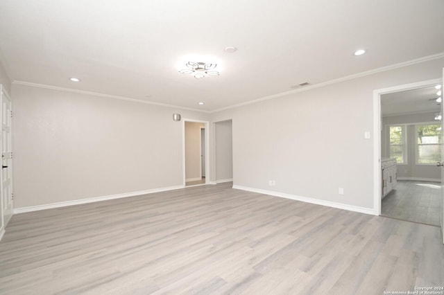 empty room with light wood-type flooring and ornamental molding