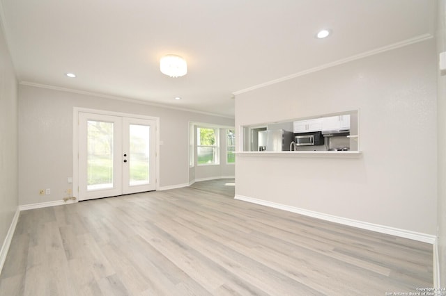 unfurnished living room with light wood-type flooring, ornamental molding, and french doors