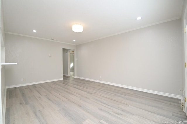 unfurnished room with crown molding and light hardwood / wood-style flooring