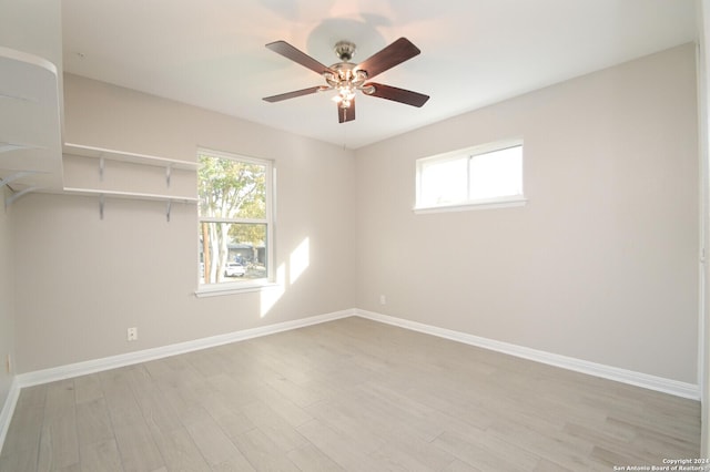 unfurnished room featuring light hardwood / wood-style flooring, a wealth of natural light, and ceiling fan