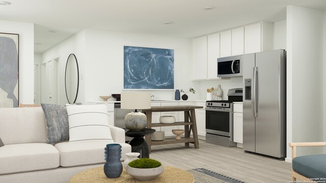 kitchen with white cabinetry, light hardwood / wood-style floors, and appliances with stainless steel finishes