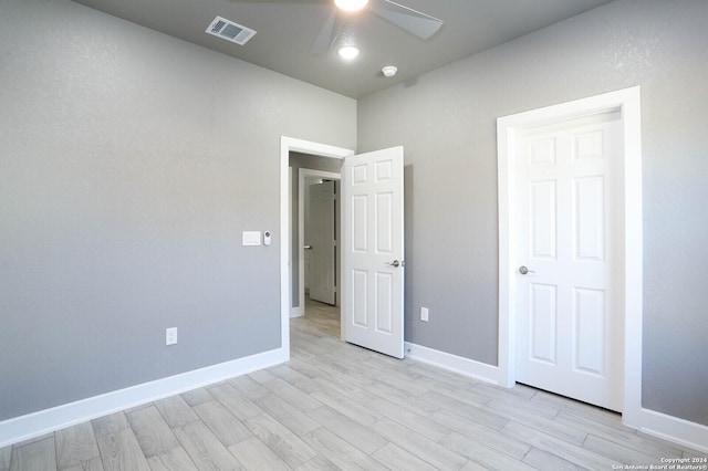 unfurnished bedroom with ceiling fan and light hardwood / wood-style flooring