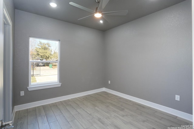 empty room featuring ceiling fan and light hardwood / wood-style floors