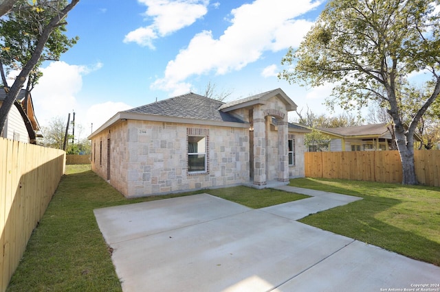 back of property featuring a yard and a patio