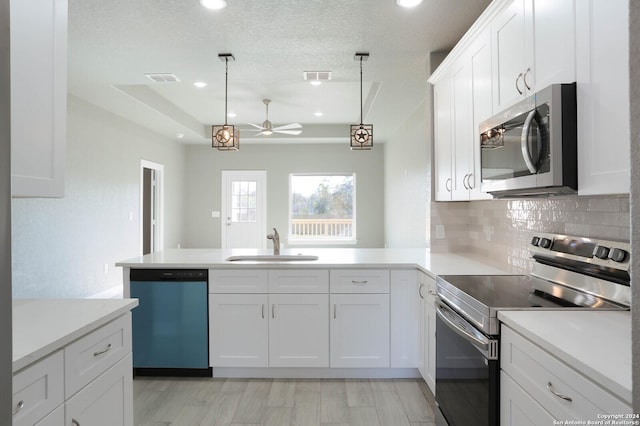 kitchen with stainless steel appliances, ceiling fan, sink, decorative light fixtures, and white cabinets