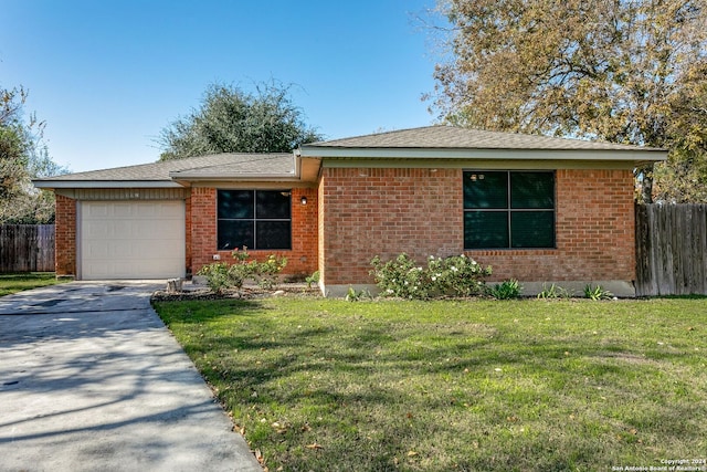 ranch-style home featuring a garage and a front lawn