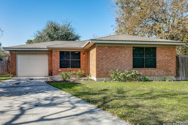 ranch-style house featuring a garage and a front yard