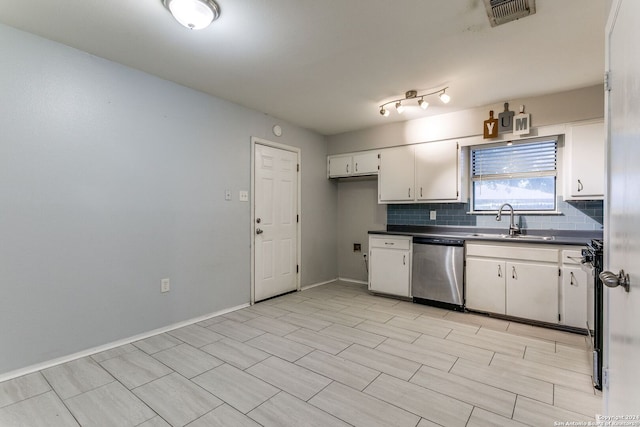 kitchen with white cabinets, dishwasher, sink, and tasteful backsplash