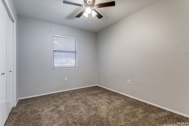 carpeted spare room with ceiling fan