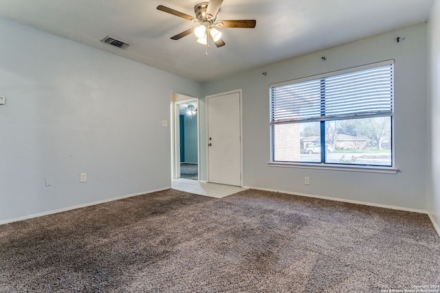 empty room with ceiling fan and light colored carpet