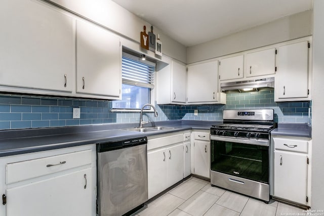 kitchen featuring sink, stainless steel appliances, light tile patterned floors, decorative backsplash, and white cabinets