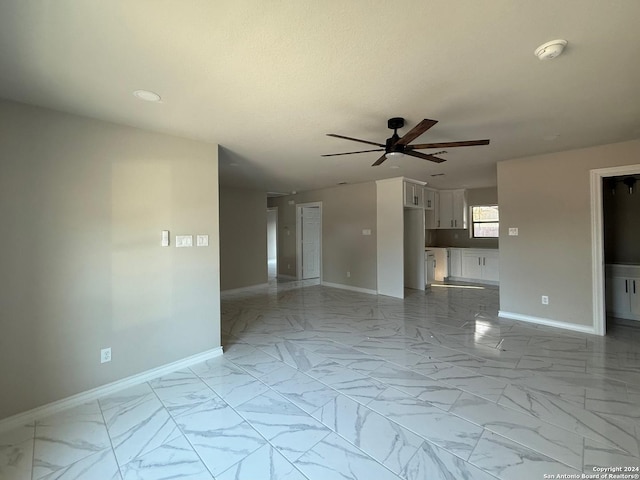 unfurnished living room with ceiling fan