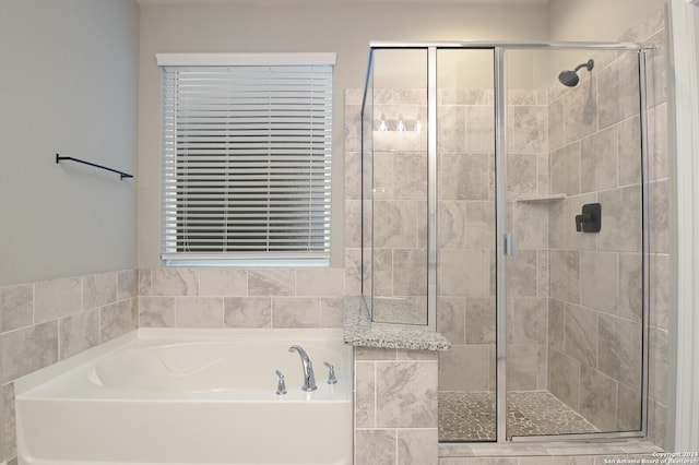 bathroom featuring separate shower and tub