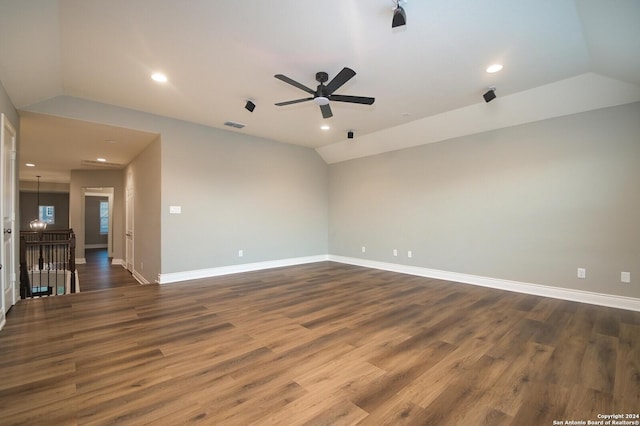 spare room featuring ceiling fan, dark wood-type flooring, and lofted ceiling