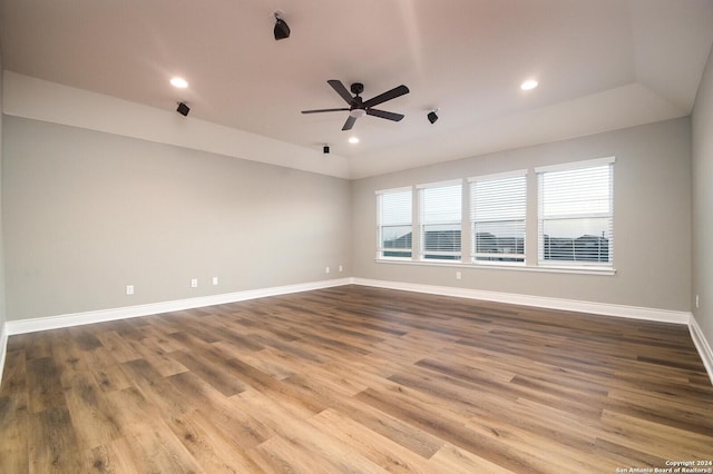 unfurnished room featuring ceiling fan, hardwood / wood-style floors, and lofted ceiling