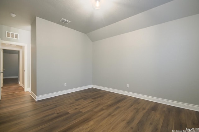 bonus room featuring dark wood-type flooring and lofted ceiling