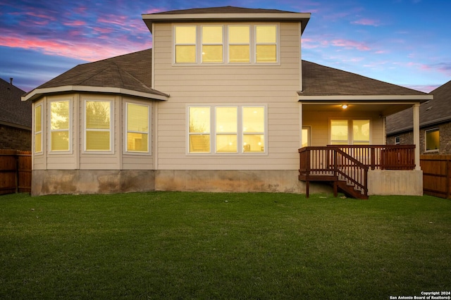 back house at dusk with a yard