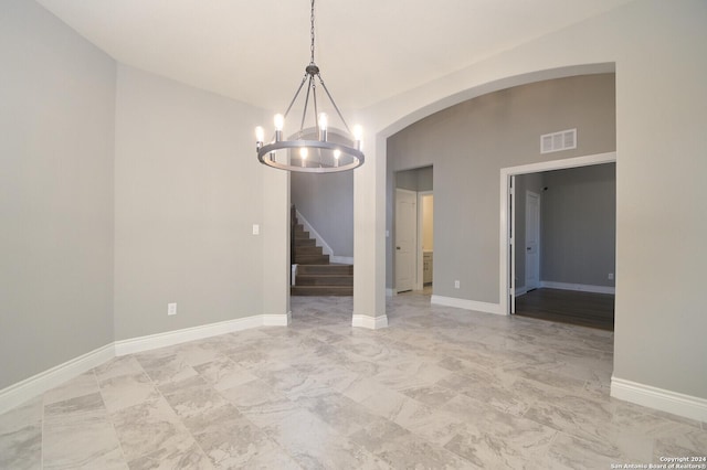 unfurnished dining area featuring a chandelier