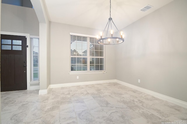 interior space featuring an inviting chandelier, plenty of natural light, and lofted ceiling