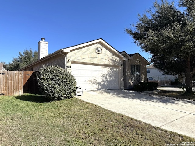 ranch-style home with a front lawn and a garage