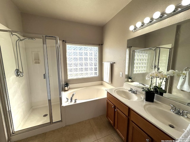 bathroom featuring vanity, tile patterned flooring, and plus walk in shower