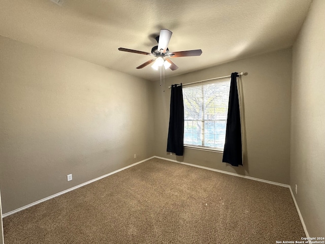 spare room with ceiling fan, carpet floors, and a textured ceiling