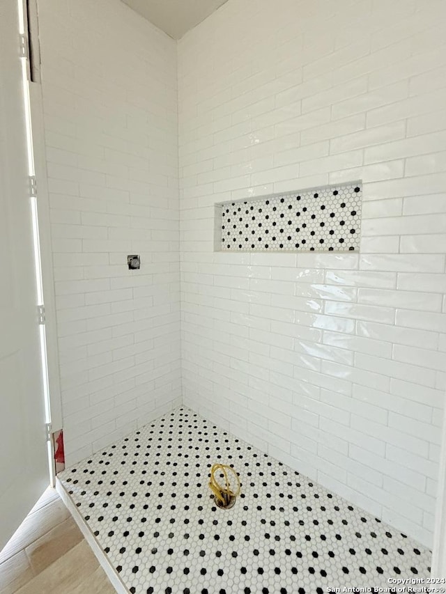 bathroom with tiled shower