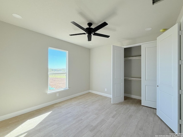 unfurnished bedroom with light wood-type flooring, a closet, and ceiling fan