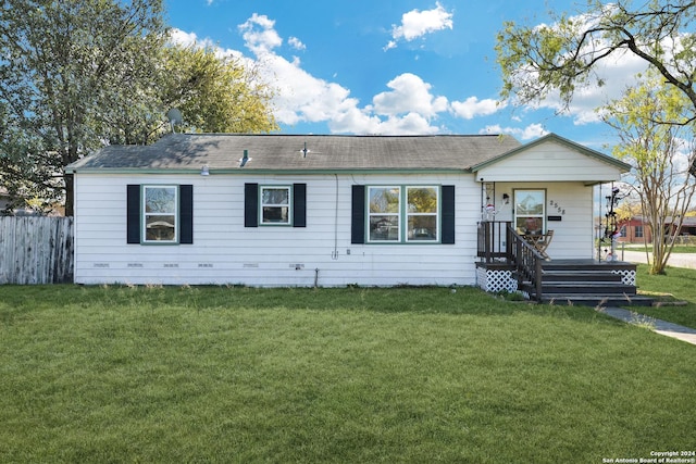 rear view of house featuring a lawn