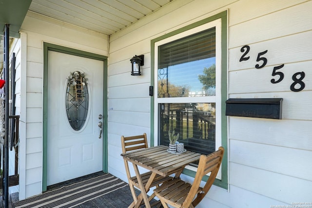 view of exterior entry with a porch