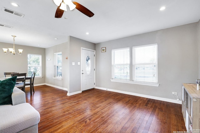 foyer with dark hardwood / wood-style flooring and ceiling fan with notable chandelier