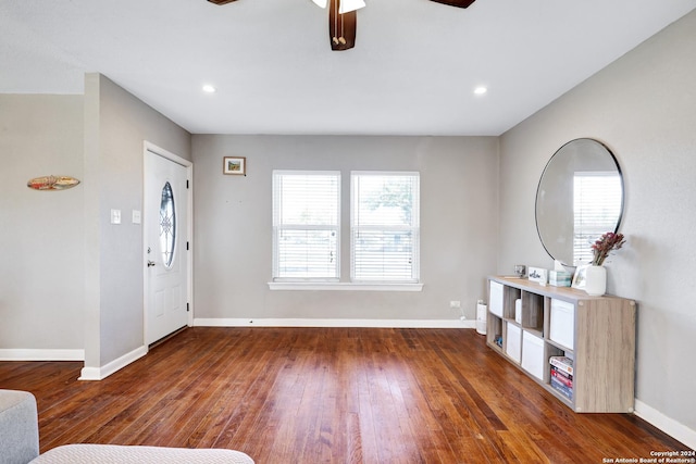 foyer entrance with ceiling fan, dark wood-type flooring, and a healthy amount of sunlight