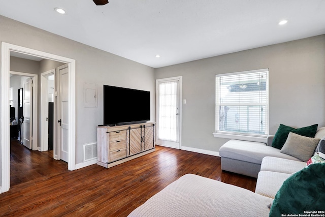 living room featuring dark hardwood / wood-style floors and ceiling fan