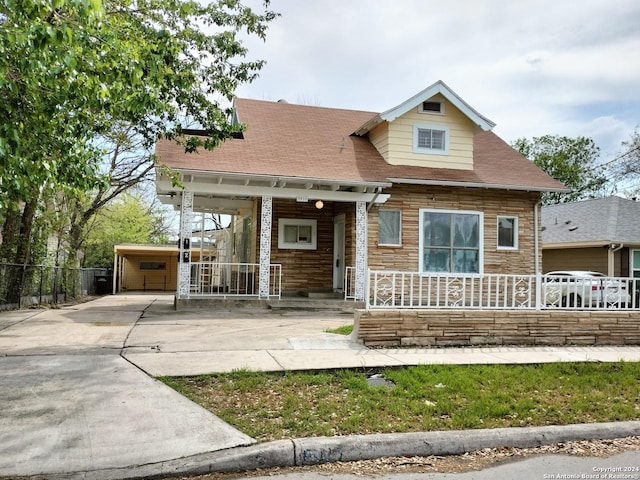 view of front of house featuring an outbuilding, covered porch, and a garage