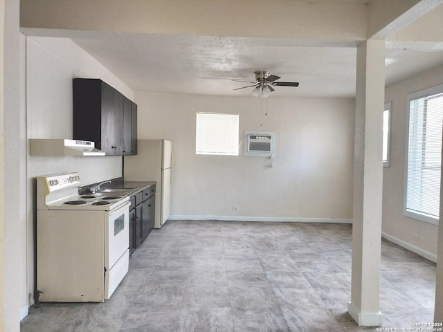 kitchen with ceiling fan, sink, a wall unit AC, a textured ceiling, and white appliances