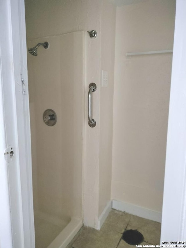 bathroom featuring tile patterned flooring and walk in shower