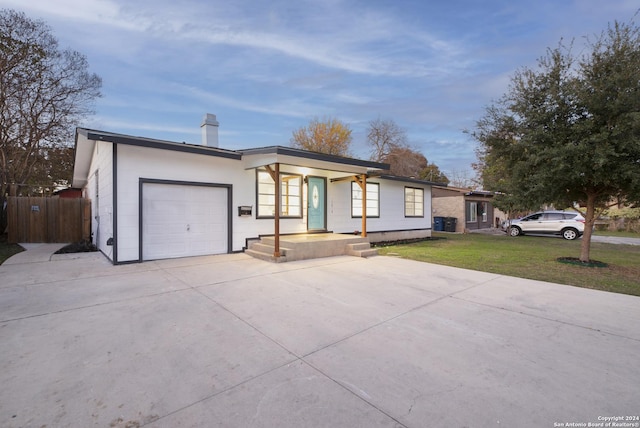 single story home with a front lawn and a garage