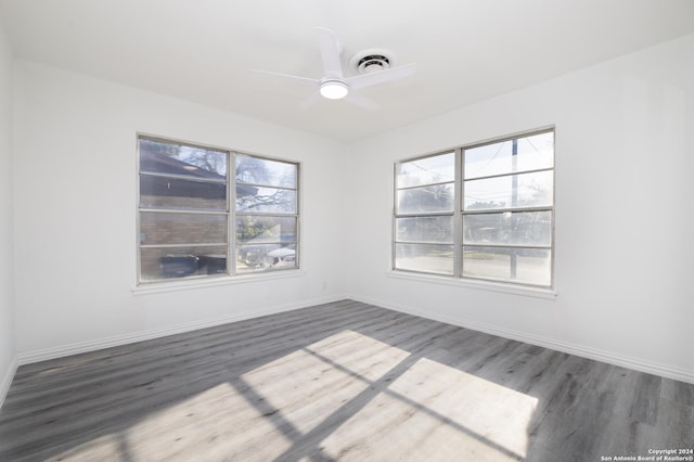 unfurnished room with ceiling fan and dark hardwood / wood-style flooring