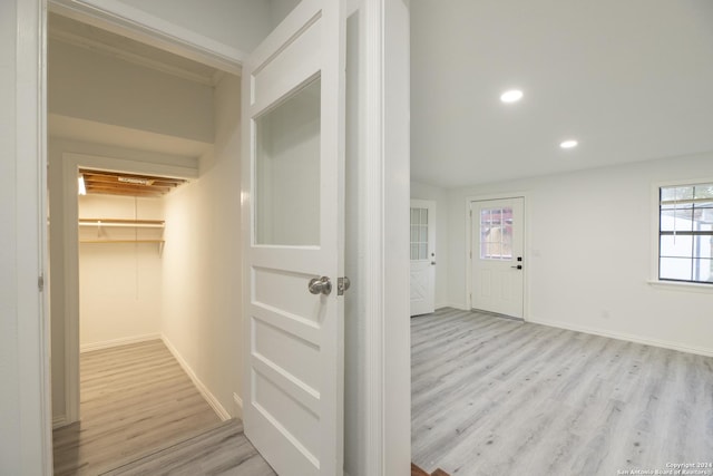 hallway with light hardwood / wood-style flooring