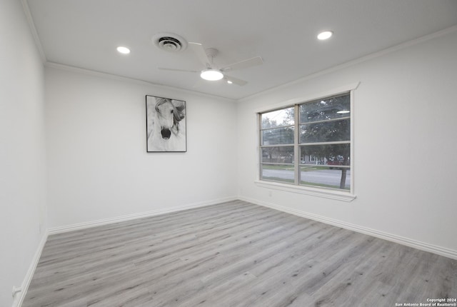 empty room featuring light hardwood / wood-style flooring, ceiling fan, and ornamental molding