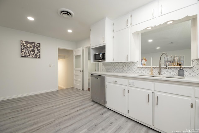 kitchen featuring white cabinetry, sink, appliances with stainless steel finishes, and light hardwood / wood-style flooring