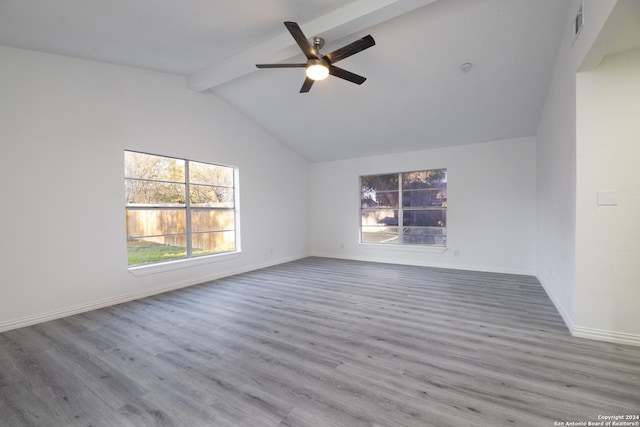 empty room featuring lofted ceiling with beams, ceiling fan, and wood-type flooring