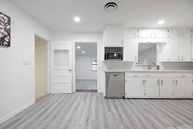 kitchen featuring light countertops, tasteful backsplash, and appliances with stainless steel finishes