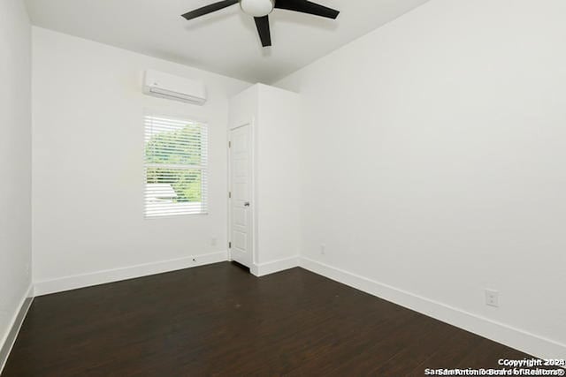 empty room with an AC wall unit, ceiling fan, and dark wood-type flooring