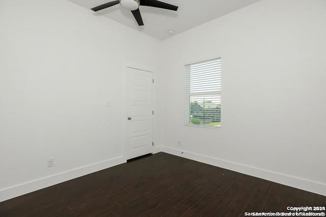 spare room with ceiling fan and dark hardwood / wood-style flooring