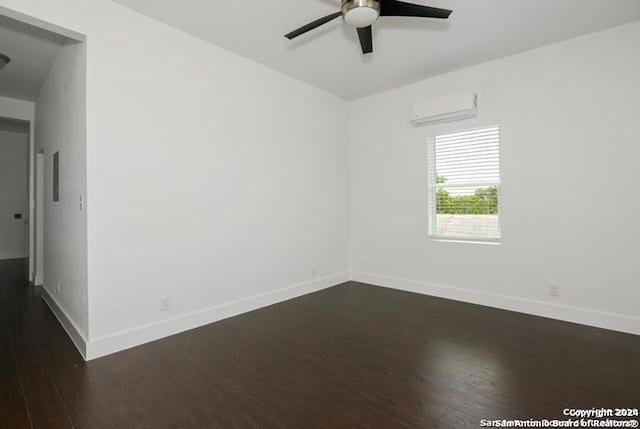 empty room with a wall mounted air conditioner, ceiling fan, and dark hardwood / wood-style flooring