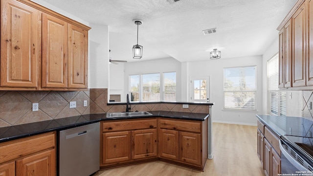 kitchen with dishwasher, sink, ceiling fan, tasteful backsplash, and light hardwood / wood-style floors